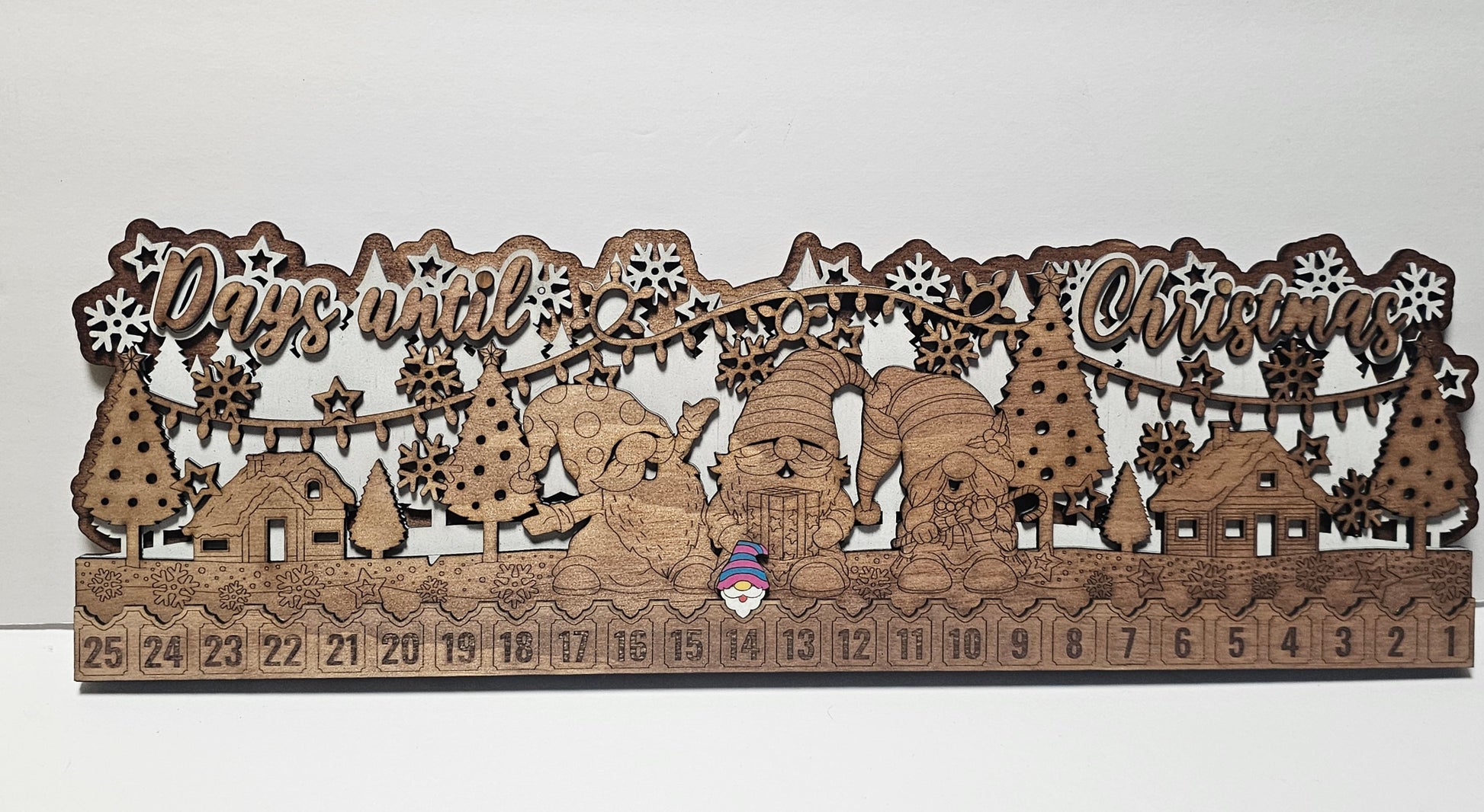 Wooden Christmas countdown calendar with festive design on a white background